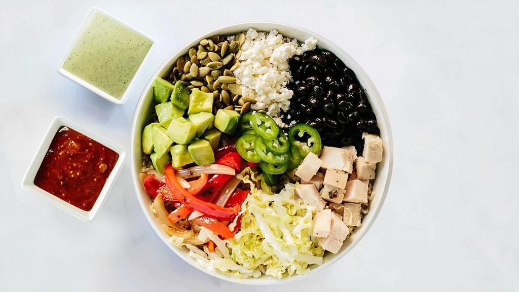 Fiesta Bowl · Brown rice, roasted chicken, avocado, Napa cabbage, jalapeno, black beans, fajita peppers and onions, queso fresco, pepitas, roasted tomatillo salsa, lime squeeze, and jalapeno-lime vinaigrette.