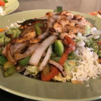 Fajitas Salad · Fresh salad greens mixed with grilled tomatoes, onions, bell peppers, guacamole, sour cream ...