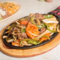 Steak Fajitas · Strips of tender skirt steak, grilled and sauteed with onions, tomatoes, bell peppers, red p...