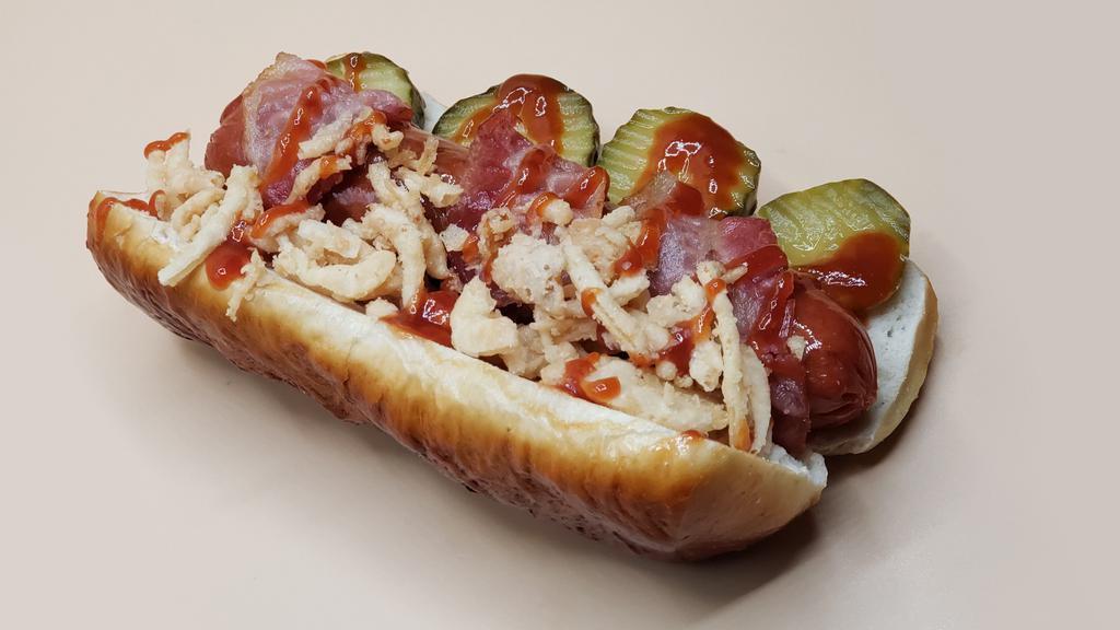 Tommy’S Favorite Dawg · Premium all-beef frank with crumbled smoked bacon, bread & butter pickles, shredded cheddar, tangy-sweet BBQ sauce, crispy onions served a steamed pretzel roll. Substitute Italian sausage or plant-based Beyond Brat for an additional charge. Substitute a poppy seed bun on request.