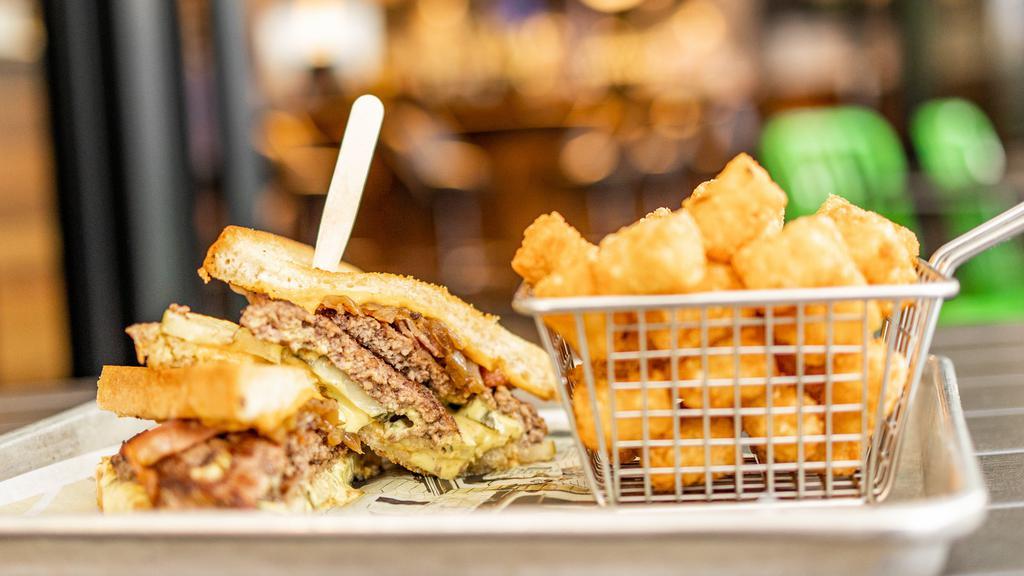 The Super Melt* · 1020-1080 cal. 1/2 lb. burger served between thick-cut bread and grilled with government cheese, bacon, caramelized onions, pickles & mustard sauce.