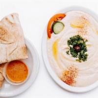 Hummus · Vegan, Gluten-Free. A creamy blend of chickpeas puréed with tahini and lemon juice drizzled ...