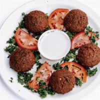 Falafel · Vegan, Gluten-Free, Contains Nuts. Crispy, fried vegan patties made with ground chickpeas, f...