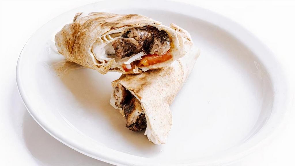 Chicken Shawarma Rolled · Grilled, seasoned chicken thigh, tomatoes, onions, and Tahini Lemon dressing