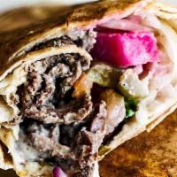 Beef Shawarma Rolled · Grilled strips of seasoned beef sirloin, greens, tomatoes, onions, turnips, pickles, and Tah...