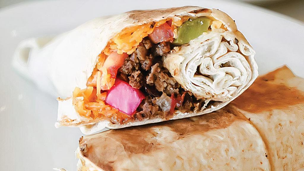 Arayiss Rolled · Contains Nuts. Sautéed mixture of lean ground beef, lightly fried pine nuts, onions, tomatoes, herbs, and spices topped with cheddar, turnips, pickles, and tomatoes