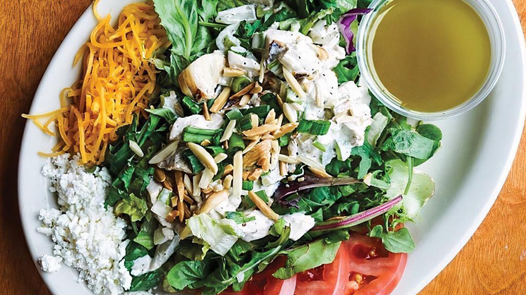 Chicken Salad · Gluten-Free, Contains Nuts. Chicken salad over mixed greens, sliced cucumbers, tomatoes, scallions, and slivered, lightly fried almonds; choice of cheddar or feta and dressing