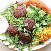 Falafel Salad · Vegetarian, Gluten-Free, Contains Nuts. Falafel patties over mixed greens, sliced cucumbers,...