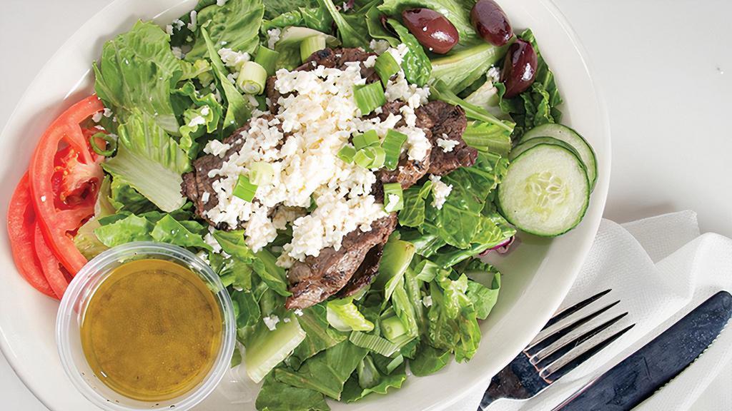 Lamb Salad · Gluten-Free. Grilled, seasoned lamb over mixed greens, sliced tomatoes and cucumbers, calamata olives, scallions, and feta; choice of dressing