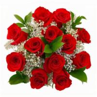 Debi Lilly Dozen Rose Bouquet · Dozen roses with filler and greens