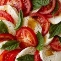 Mozzarella Caprese Salad · Vine ripe tomatoes topped with Dallas mozzarella and basil, drizzled with balsamic and extra...