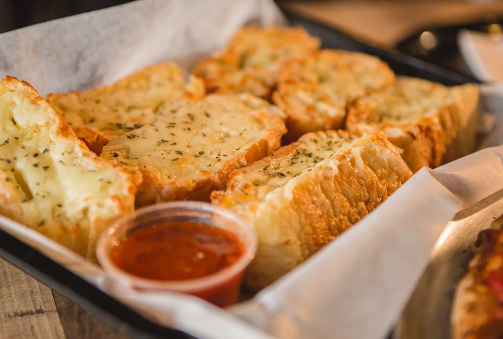 Garlic Bread W/Cheese · Garlic toast covered in Mozzarella dashed with oregano and it comes with a cup of marinara sauce.