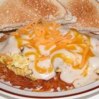 Country Scramble · Two eggs scrambled with sausage, cheese, and white gravy, served over hash browns, with toast.