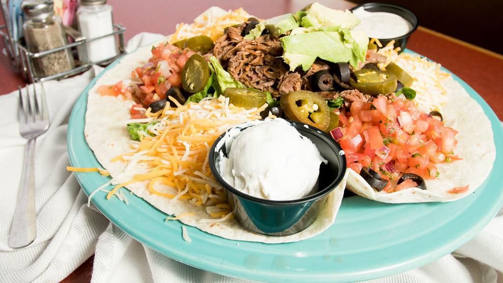 Southwest Taco Salad · Traditional filling with jalapenos, black olives, and a side of sour cream.