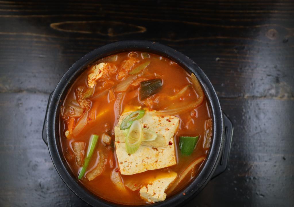 Kimchi Stew/ 김치찌개 · Famous Korean traditional stew. Kimchi, pork, tofu and veggies in a spicy broth. Served with rice.
