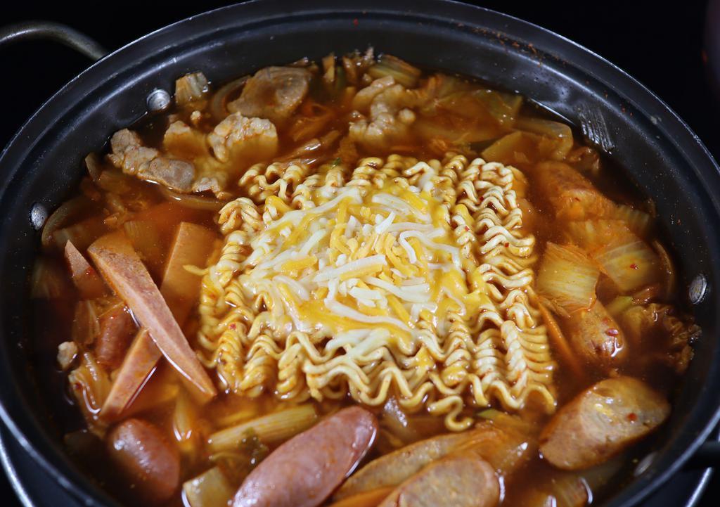 Army Base Stew / Budae Jjigae · A Korean/American fusion dish with sausage, spam, veggies, tofu, kimchi, and hot dog in a rich, spicy broth. Served with two sides of rice.