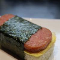 Musubi · Pan fried spam and layer of egg on top of block of rice, wrap in roasted nori (seaweed).