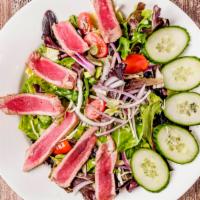 Seared Tuna Salad · Gluten free. Fresh seared tuna over grape tomatoes, red onion, lettuce, baby greens and citr...