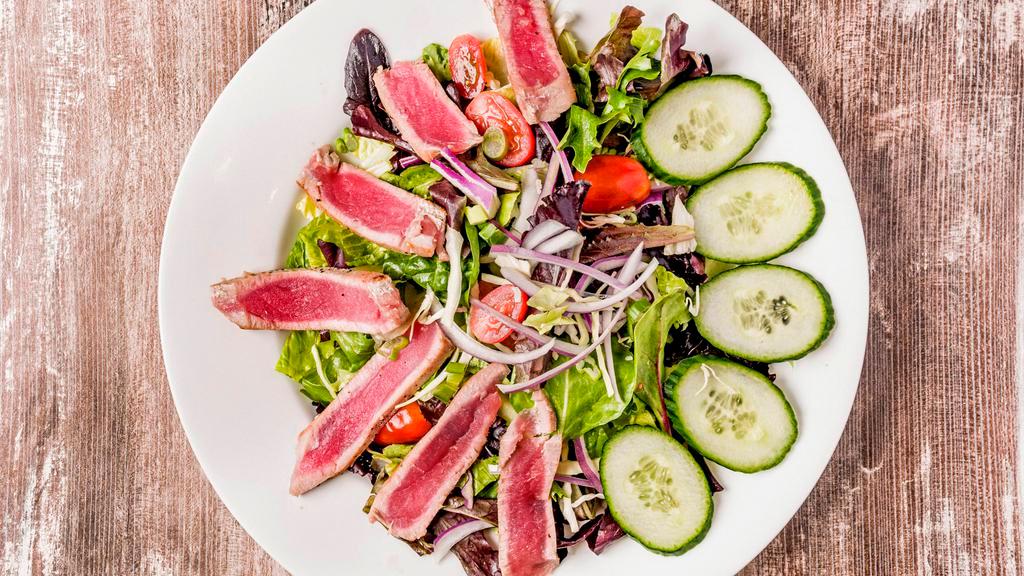 Seared Tuna Salad · Gluten free. Fresh seared tuna over grape tomatoes, red onion, lettuce, baby greens and citrus dressing.
