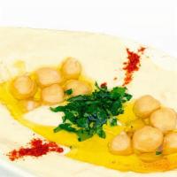 Hummus · Vegan. Pureed chickpeas, tahini, fresh lemon juice, garlic, and olive oil.