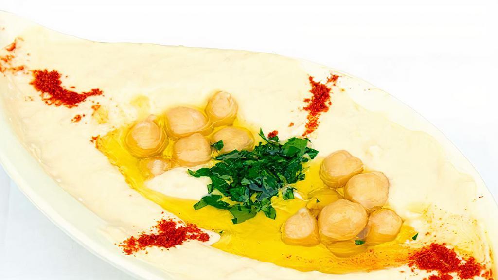 Hummus · Vegan. Pureed chickpeas, tahini, fresh lemon juice, garlic, and olive oil.