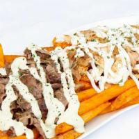 Shawarma Fries · French fries topped with chicken and/or beef shawarma, tahini sauce and/or garlic sauce.