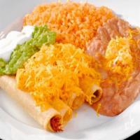 Four Rolled Tacos · four rolled tacos(flautas) with cheese,sour cream and guacamole on top and rice and beans on...