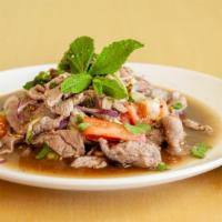 Spicy Beef Salad* · Sliced cooked beef, mixed with tomatoes, onions, cucumbers, chili, lime juice, mint leaves, ...