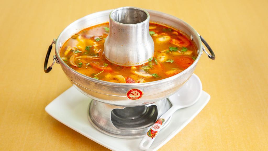 Tom Yum Soup* (Shrimp Or Seafood) · Hot and sour soup with mushrooms in a broth made of Thai spices, chili paste, tomatoes, lime juice, onions, and cilantro.