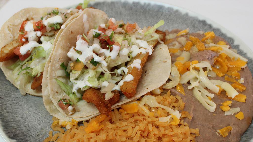 2 Fish Tacos · Includes rice and beans.