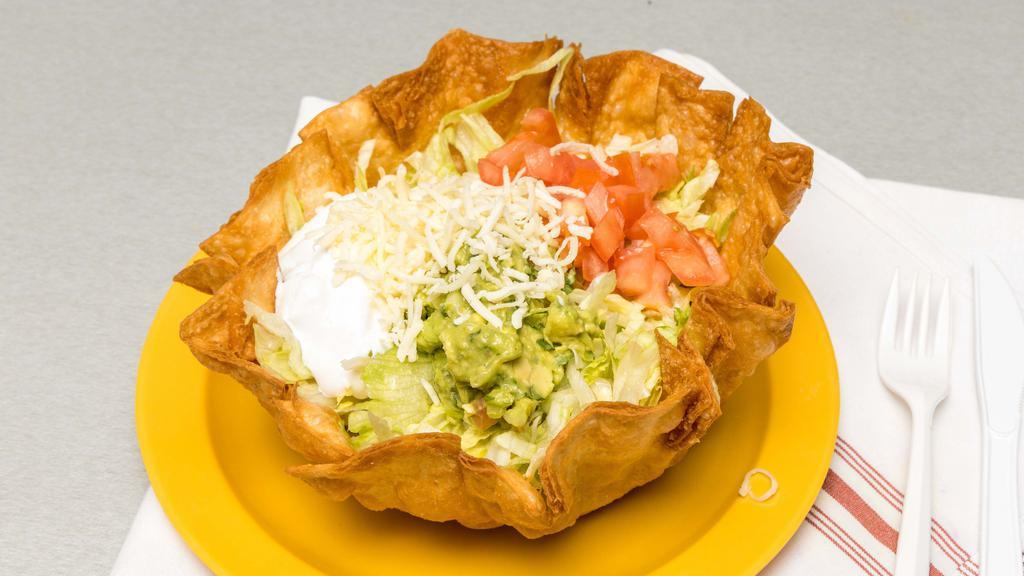 Taco Salad · Fried flour tortilla, lettuce, tomato, guacamole, cheese with your choice of meet.