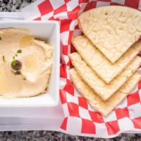Hummus · Mashed chickpeas blended with tahini sauce, lemon juice, and fresh garlic. Served with warm ...