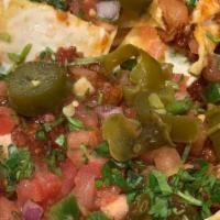 Manny'S Loaded Nachos · Chicken or beef on top of fresh warm tortilla chips with melted cheese,green onion, tomatoes...