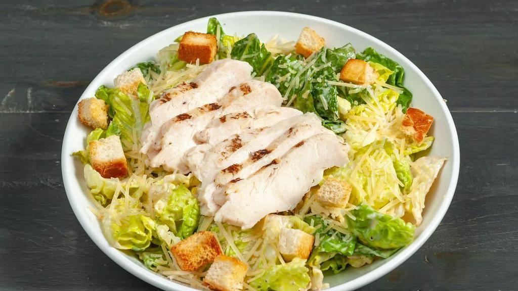 Caesar Salad Chicken · Creamy Caesar dressing tossed in fresh romaine lettuce topped with Parmesan cheese and croutons with chicken.