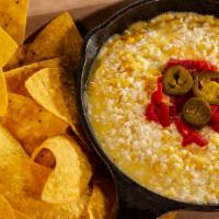 Cheesy Jalapeno Corn Dip & Chips · Parmesan, cheddar, cotija, & pepper jack cheeses, corn, & jalapenos
