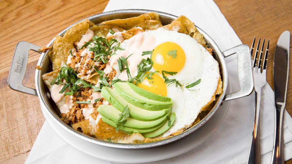 Chilaquiles · Corn tortilla chips, tomatillo salsa, chihuahua cheese, avocado & cholula sour cream.  (no toast, no potato)