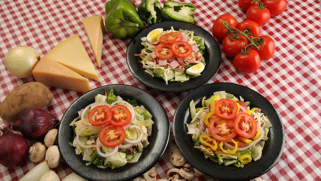 Garden Salad · Crisp iceberg and romaine lettuce blend, Provolone cheese, Roma tomatoes and red onions.