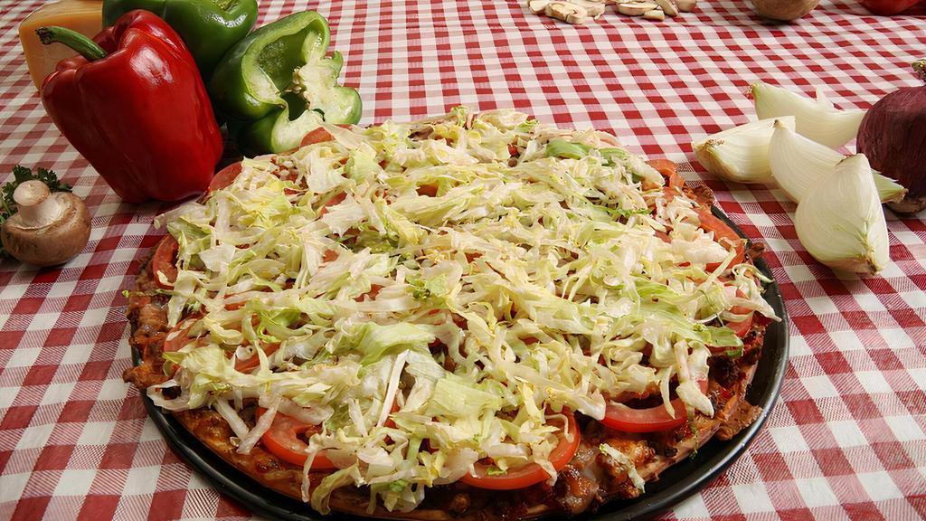 Mexican · Taco meat or grilled chicken, refried beans, salsa, Cheddar cheese blend, lettuce and Roma tomatoes. Sour cream and jalapeno peppers on the side.