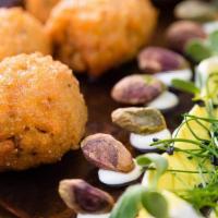 Four Cheese Arancini · Hand-rolled cheesy rice balls breaded and lightly fried, served with spicy tomato sauce