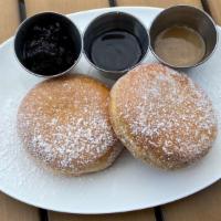 Italian Bomboloni Donut · Individual Italian Bomboloni Donut tossed in sugar, served with chocolate and caramel dippin...