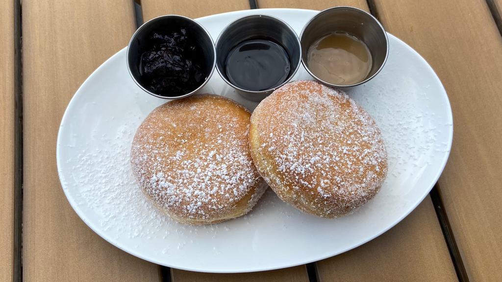 Italian Bomboloni Donut · Individual Italian Bomboloni Donut tossed in sugar, served with chocolate and caramel dipping sauces