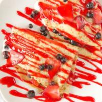 Berry Crepes · Stuffed With homemade crepe filling, strawberries, and blueberries, topped with strawberry g...