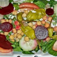 Greek Salad · Lettuce with feta cheese, tomatoes, cucumbers. Greek olives, pepperoncini, beets, and chickp...