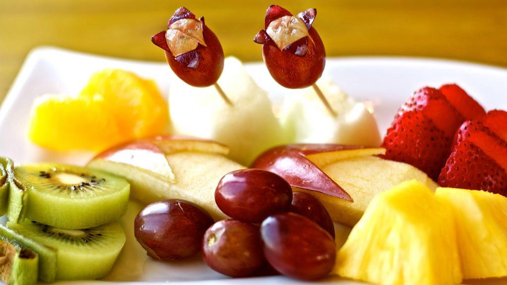 Fresh Fruit Plate · An assortment of fresh fruits. Fruits: apple, kiwi, banana, strawberry, grapes, orange, melon, and pineapple.