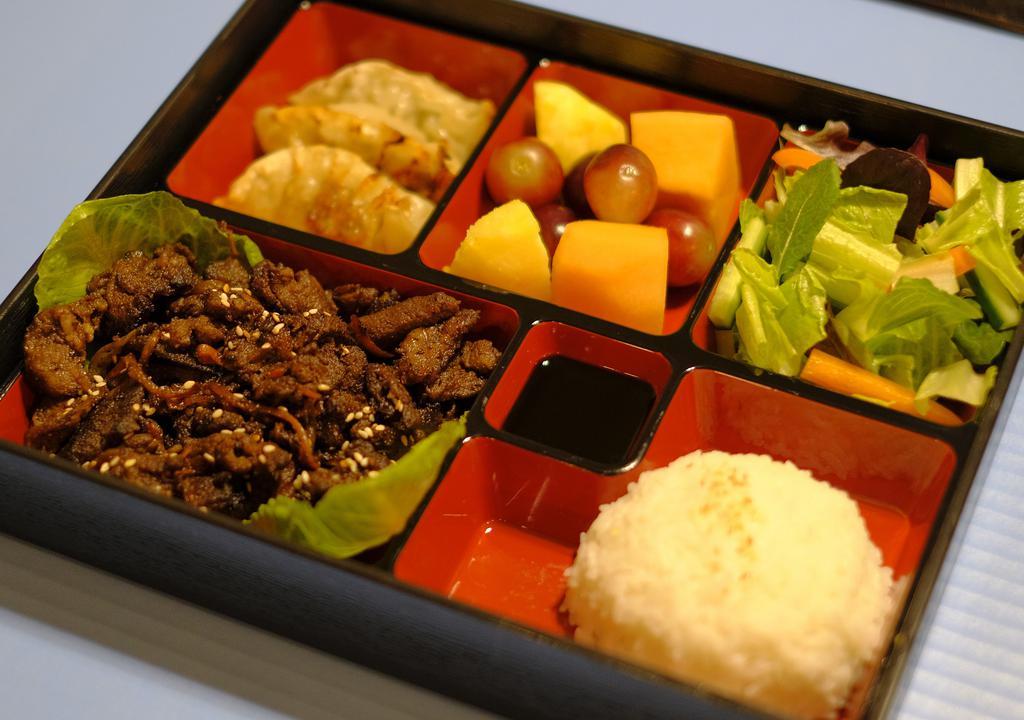 Bento Box · Cha's original unique bento (lunch) box. Contains: choice of meat, house or caesar salad with dressing, three chicken dumpling, rice, fresh fruits (pineapple, melon, and grapes).