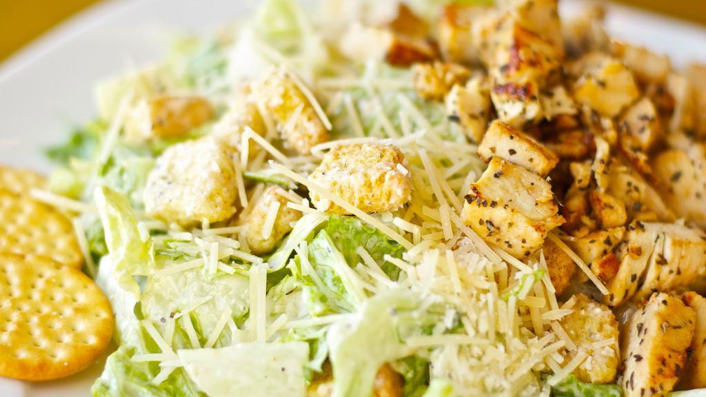 Chicken Caesar Salad · Freshly made caesar salad. Base of romaine with caesar dressing, chicken, croutons, crackers, parmesan cheese.