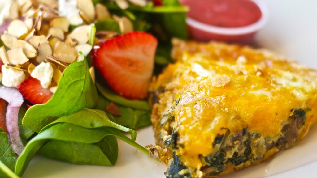 Spinach And Mushroom Quiche · Fresh slice of our homemade quiche. Comes with a spinach strawberry side salad and dressing. Quiche contains: red onion, bell-pepper, mushroom, spinach, and cheese. (regular (ham) or veggie (tomato) See spinach strawberry salad for content.
