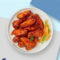 Bussin' Buffalo Wings   · Fresh chicken wings breaded, fried until golden brown, and tossed in buffalo sauce. Served w...
