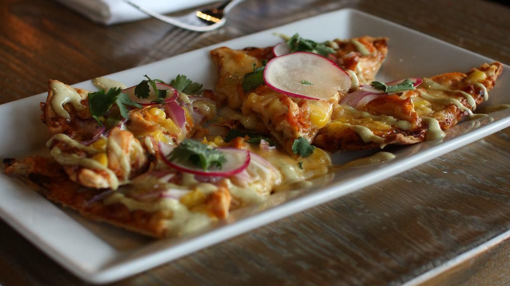 Chile-Braised Chicken Flatbread · roasted corn, red onion, jalapeño aioli, melted cheeses, fresh cilantro