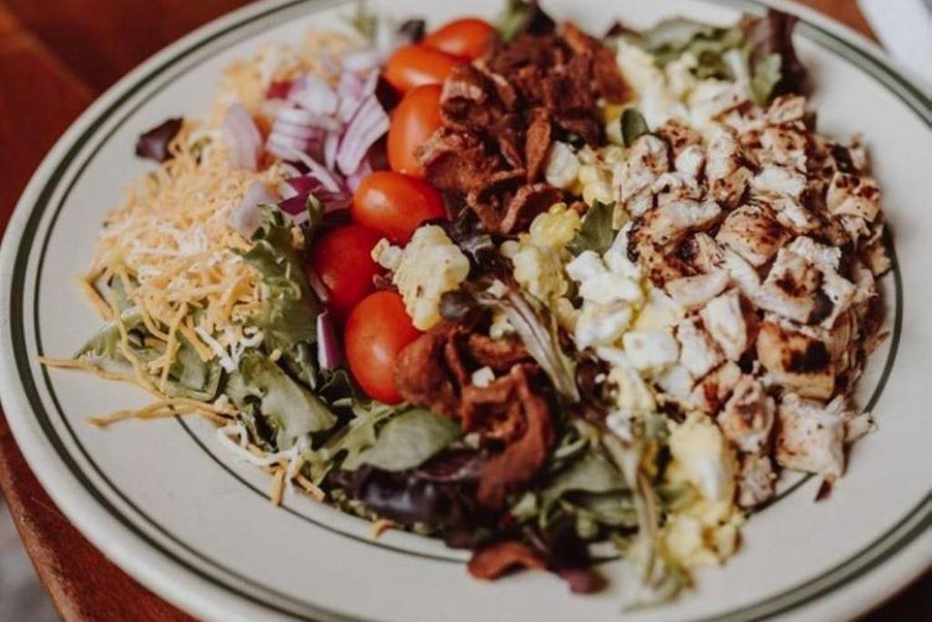 Cobb Salad · Mixed Greens, Crumbled Bacon, Red Onion, Diced Chicken, Hard Boiled Egg, Tomatoes, Shredded Cheddar Jack, Roasted Corn